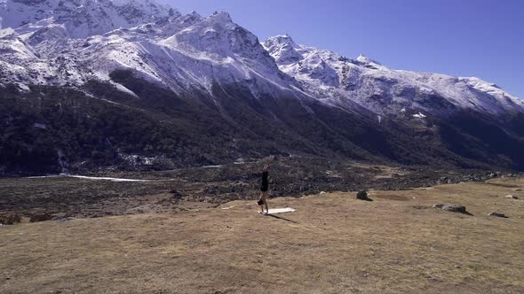 Man doing yoga in the Kyaniji Valley in Nepal