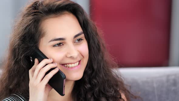 Smiling Face of Beautiful Caucasian Woman with Natural Makeup Talking Using Smartphone Closeup