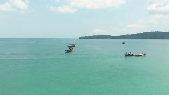 Fisherman boats off Koh Rong Samloem. Tropical sea waters on sunny day. Aerial view 