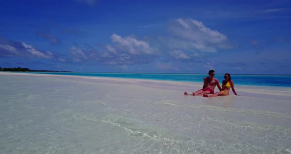Beautiful people on honeymoon vacation enjoy life on beach on clean white sand 4K background