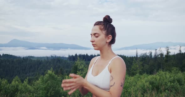 Young Woman with Closed Eyes Meditating on Nature
