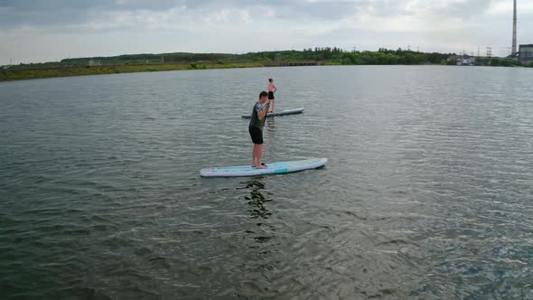 People standing firmly on SUP board and paddling