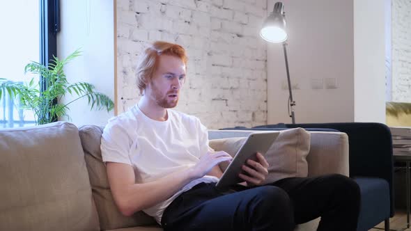 Reaction to Loss By Creative Man Using Tablet in Office