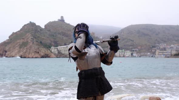 Woman Warrior in Armor Against Fortress on Rock and Sea