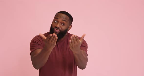Young African American Man Flirting Heart Gesture Isolated on Pink Background