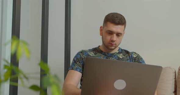 Man Freelancer Using Laptop Online Working in Internet, Guy Typing on Computer Surfing Web Looking