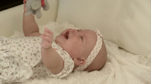 Happy Baby Playing with Bed Side Toy, Smiling