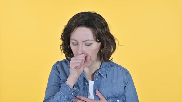 Sick Old Woman Coughing on Yellow Background 