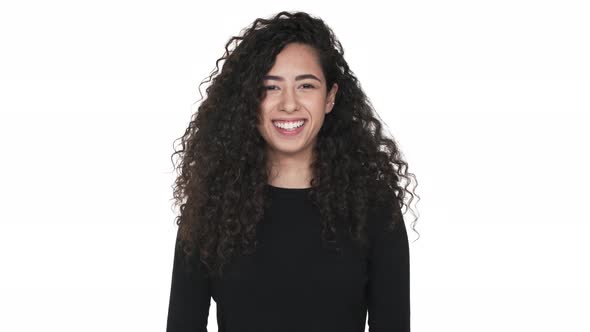 Portrait of Pretty Lady with Long Curly Locks Laughing Having Fun Over White Background