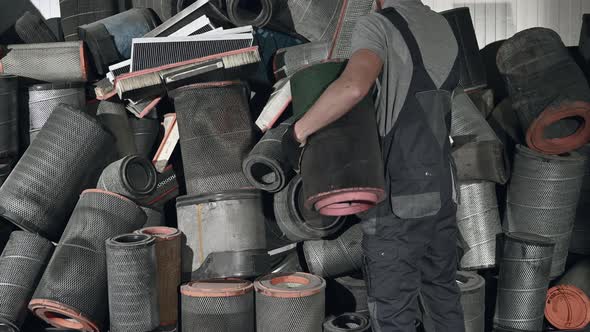 Trucks Mechanic and the Pile of Used Air Filters