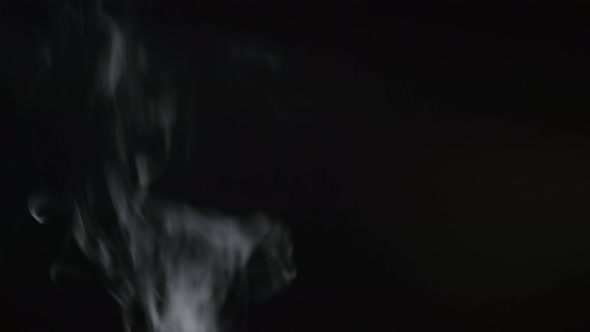 White smoke, fog, mist, vapor on a black background.