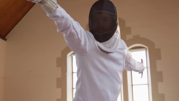 Female fencer athlete during a fencing training in a gym