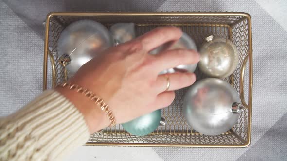 Closeup of Hands of Parents and Children Take Christmas Gifts Out of the Box