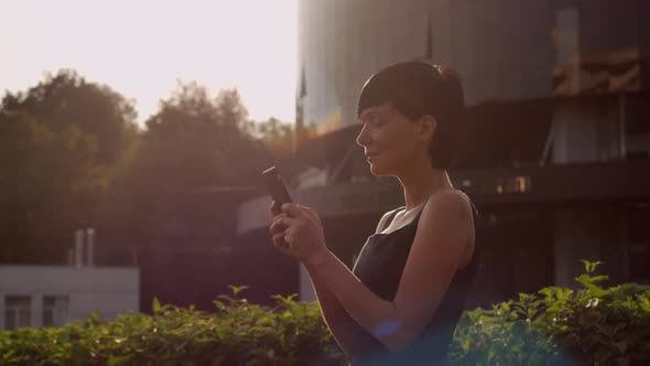 Business Lady Texting on Mobile Near Office