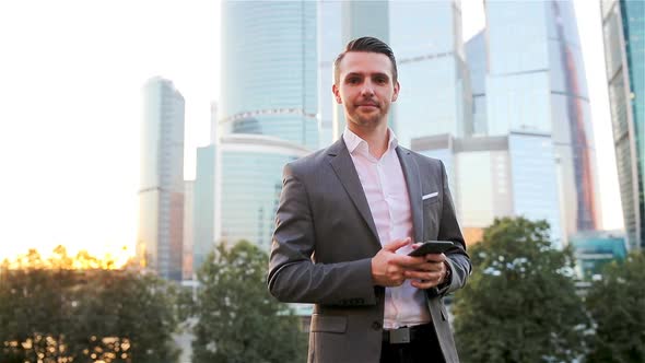 Young Caucasian Man Holding Smartphone for Business Work.