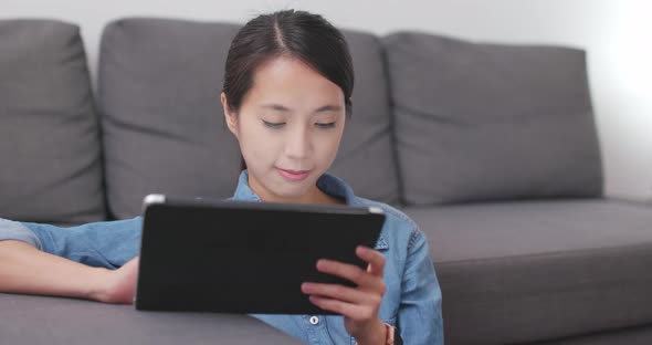 Woman watching tablet computer
