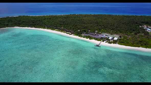 Aerial seascape of beautiful shore beach journey by turquoise water and white sandy background of a 