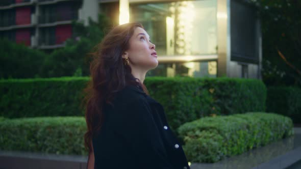 Confident Asian Businesswoman Walking Alone Watching City Architecture Side View