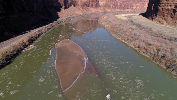 Aerial view flying over Colorado River through canyon in Moab