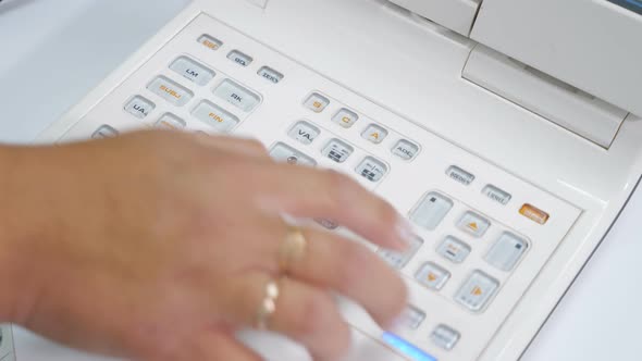 Close Up Hands of Woman Doctor Working with the Refractometer Machine