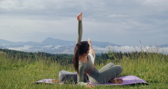 Two Women Doing Flexible Exercises on Yoga Mat Outdoors