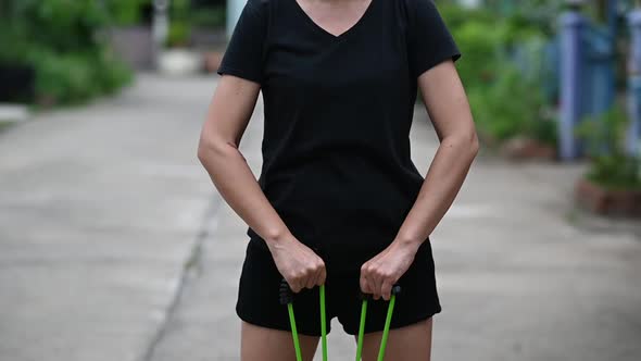 A young woman exercising with an elastic rope.Slow motion footage.