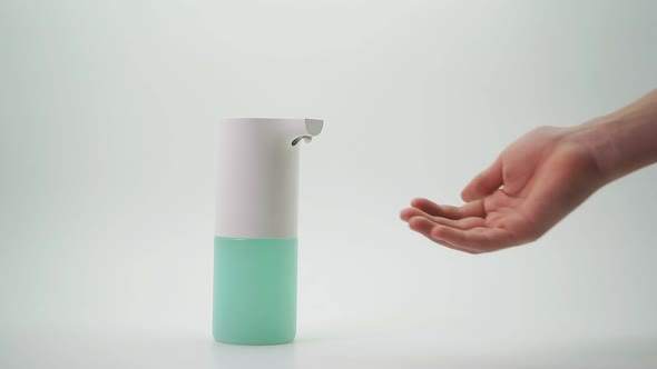 Close-up of a Woman's Hand Using an Automatic Dispenser. Concept of Infection Prevention During the