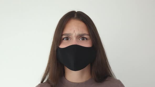 Portrait Young Brunette Female in Black Protective Medical Mask Aggressive Scold