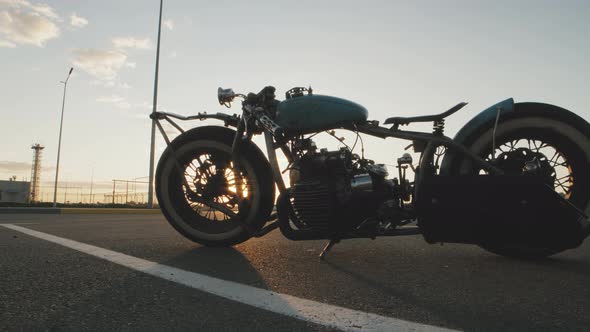 Closeup Dolly Shot of Custom Cafe Racer Motorcycle at Sunset on Street