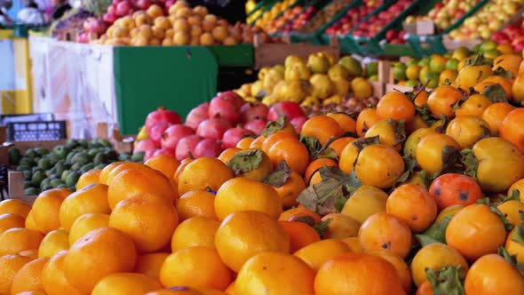 Showcase with Various Fruits, Persimmons, Tangerines, Pears and More in the Street Market