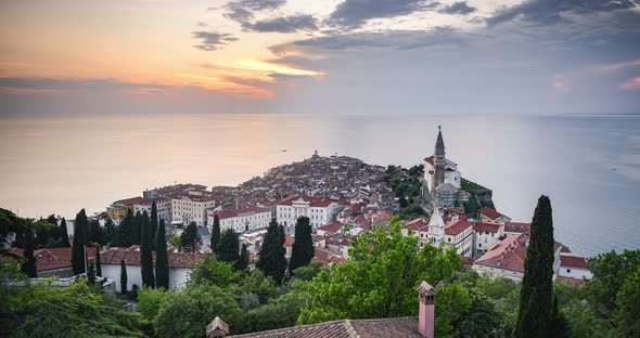 Timelapse of Slovenia at Piran old town with Mediterranean Sea and traditional red rooftops. Elevate