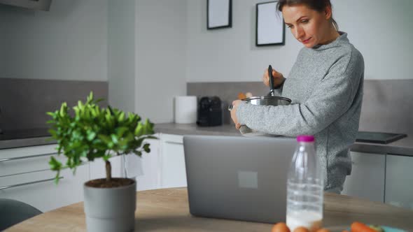 Woman Looking Recipe Online While Cooking