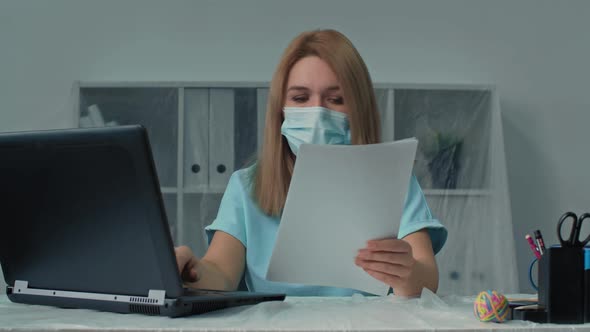Portrait of Confident Woman Entrepreneur in Protective Mask Working with Computer and Papers in