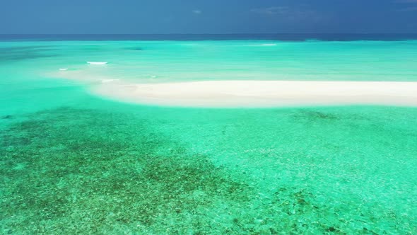 Beautiful drone travel shot of a white sandy paradise beach and aqua turquoise water background in v