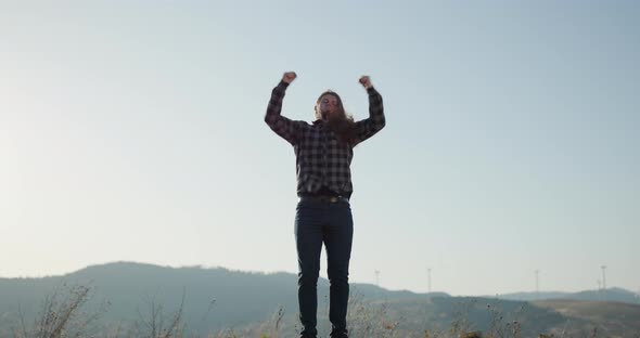 Muscular Young Male Athlete Flexing Arms Screaming Excited for Winning Success