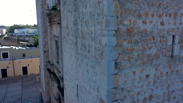 Extreme closeup aerial ascent on corner of the backlit Cathedral de San Gervasio in Valladolid, Yuca