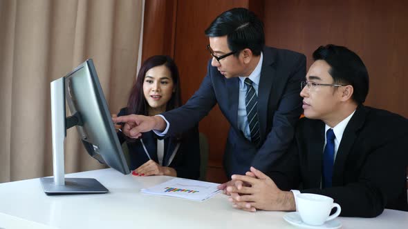 Business people group working together at office desk and checking a financial report.