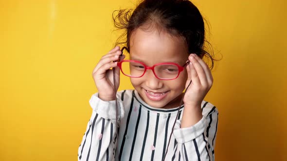 Portrait of Child Girl Looking the Camera Laughing and Wearing Eyeglass