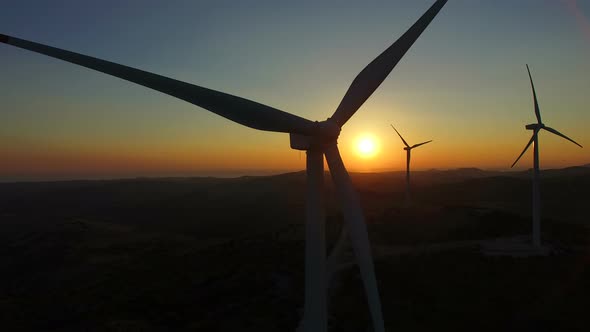 Close up of rotating windmill blades at sunset