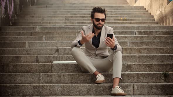 Man Freelance With Smartphone Outdoors. Businessman With Phone On Stairs. Freelancer Internet Online