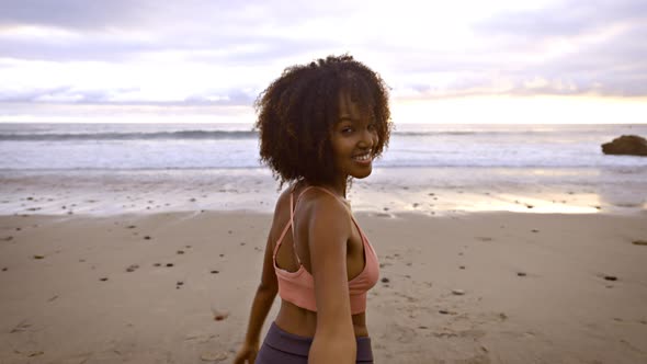 Slow motion shot of an Somali woman jogging on the beach