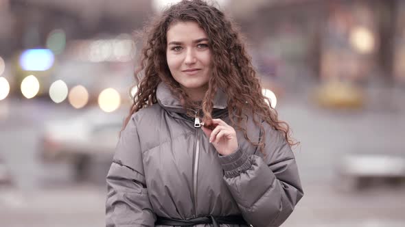 Pretty Young Female City Dweller Is Walking Alone on Street at Cold Day Medium Portrait of Charming