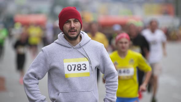 Portrait Face of Tired Athlete Runner on Marathon Standing Looking at Camera