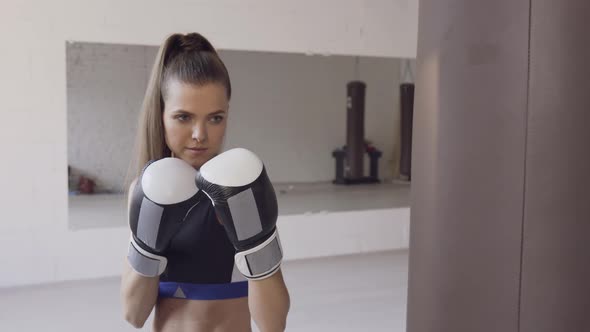 An Experienced Male Trainer Teaches a Young Female Athlete the Technique of Correct Hand Strike