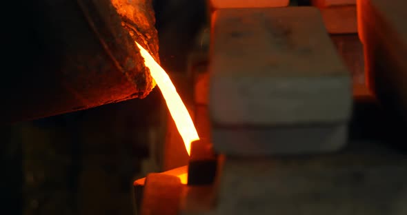 Molten metal being poured in mold at foundry workshop 4k