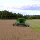 The Green Combine Moves on the Field and Cuts the Grain - VideoHive Item for Sale