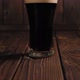 Closeup of a Glass of Chilled Dark Beer on a Wooden Surface - VideoHive Item for Sale