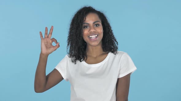 Okay Sign By African Girl Isolated on Blue Background
