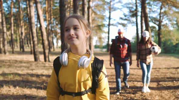 Happy Family Hiking Through a Forest