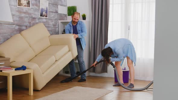 Man Pick Up Sofa for Cleaning